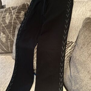 Woman BC B G  black pant. Mid rise.  Has leather laces on es h side of the let